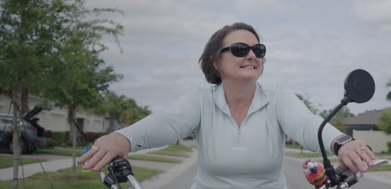 Stephanie, a patient advocate riding a bike