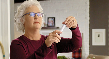Melaine, a patient advocate preparing to self-infuse in her home