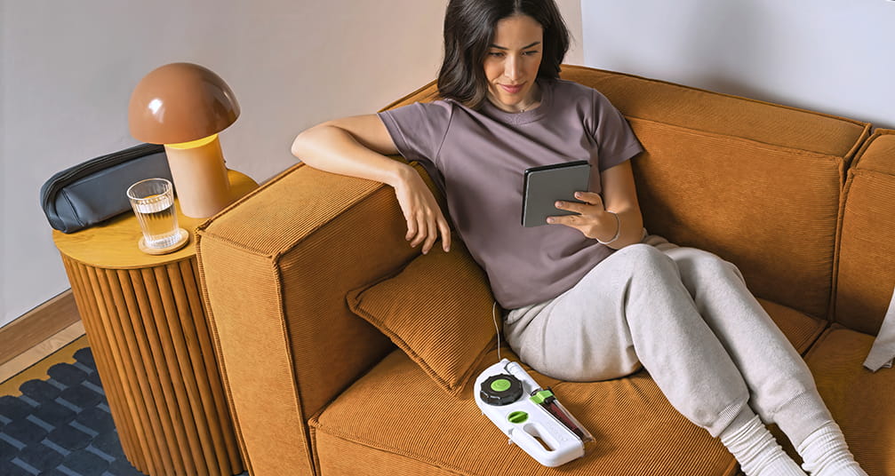 Woman relaxing on her couch during a Hizentra self-infusion