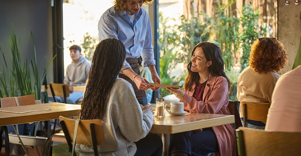 Two women ordering at a restaurant