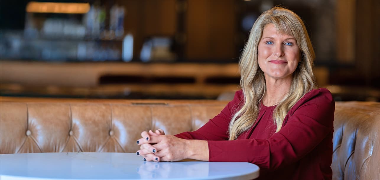 Woman smiling while sitting at a table